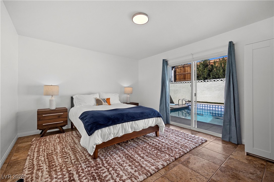 1554 Raindance Way Las Vegas, NV 89169 - Photo 18 of 25 Bedroom with access to outside and baseboards