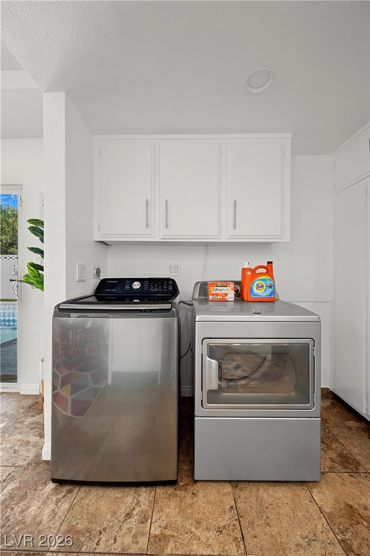 1554 Raindance Way Las Vegas, NV 89169 - Photo 21 of 25 Laundry area with cabinet space and independent washer and dryer