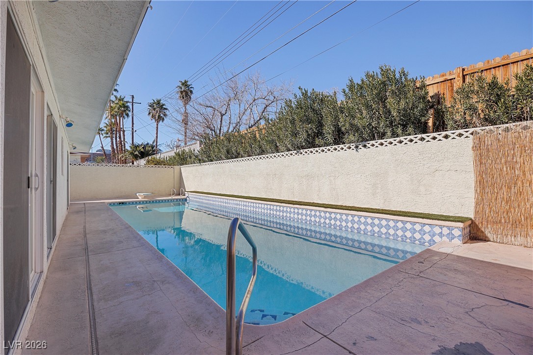 1554 Raindance Way Las Vegas, NV 89169 - Photo 7 of 25 View of swimming pool featuring a fenced backyard, a diving board, a fenced in pool, and a patio