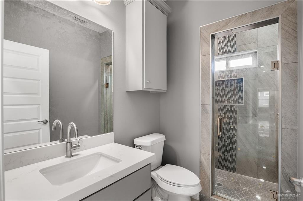 1402 Tee Box Drive Weslaco, TX 78596 - Photo 12 of 20 a bathroom with a sink a toilet and shower