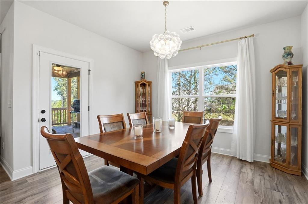 449 Banff Drive Winder, GA 30680 - Photo 16 of 56 a view of a dining room with furniture window and wooden floor