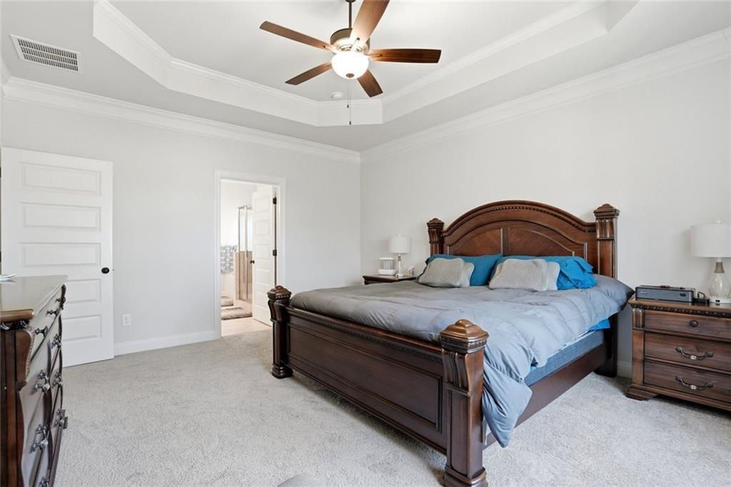 449 Banff Drive Winder, GA 30680 - Photo 19 of 56 a bedroom with a bed and a chandelier