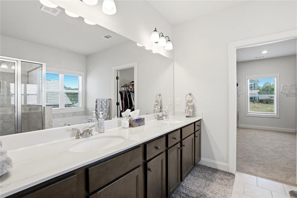 449 Banff Drive Winder, GA 30680 - Photo 20 of 56 a bathroom with a sink double vanity granite and a mirror