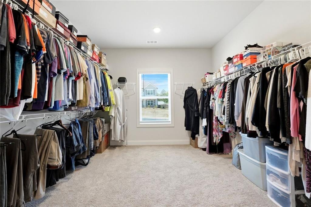 449 Banff Drive Winder, GA 30680 - Photo 23 of 56 a view of walk in closet with clothes and shoes