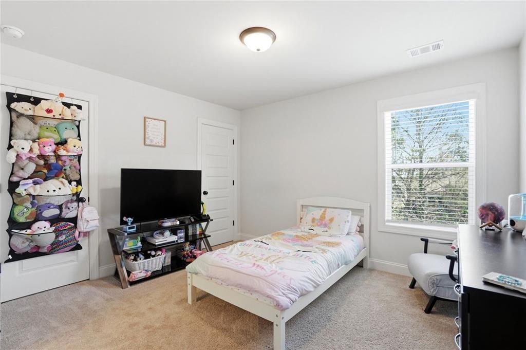 449 Banff Drive Winder, GA 30680 - Photo 26 of 56 a bedroom with a bed and a flat screen tv
