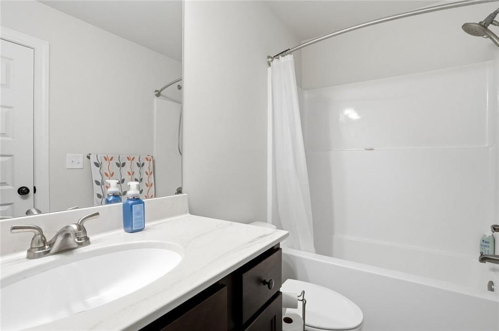 449 Banff Drive Winder, GA 30680 - Photo 27 of 56 a bathroom with a sink and a mirror