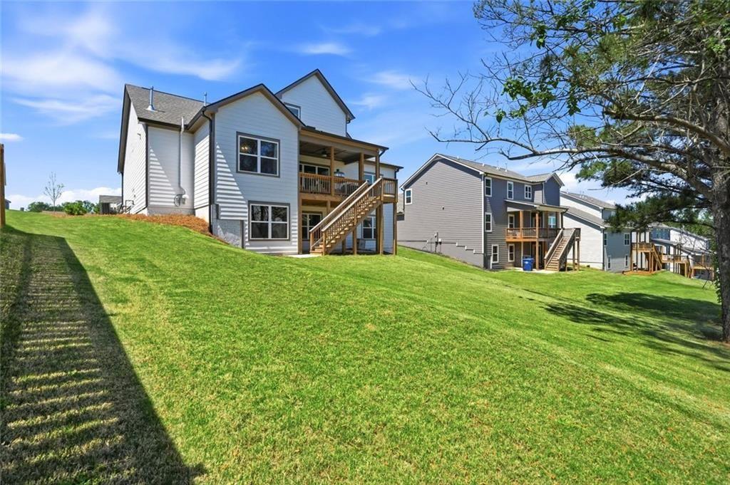 449 Banff Drive Winder, GA 30680 - Photo 42 of 56 a view of a big house with a big yard and large trees