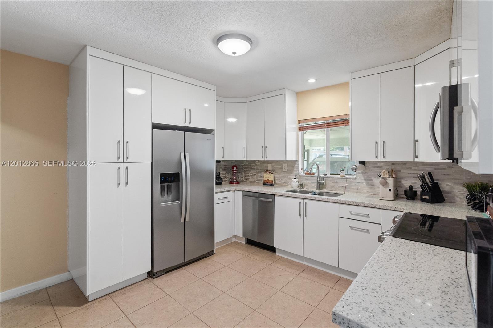 5300 Northwest 30th Place Miami, FL 33142 - Photo 5 of 35 a kitchen with stainless steel appliances granite countertop a refrigerator sink and cabinets