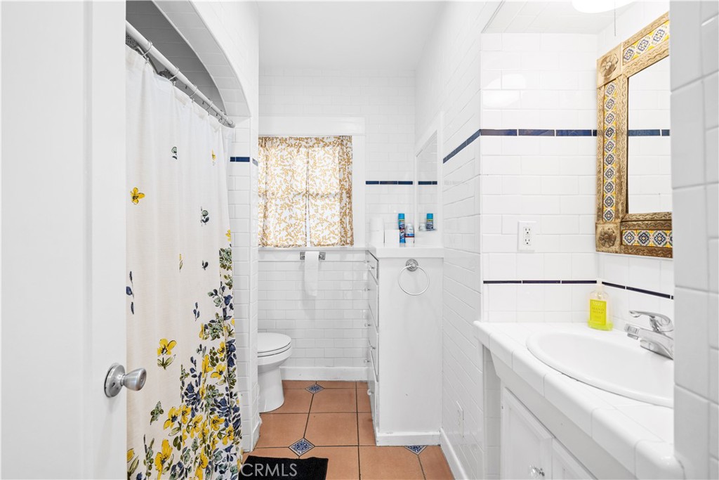 1415 South 2nd Street Alhambra, CA 91801 - Photo 11 of 58 a bathroom with a sink and a shower curtain