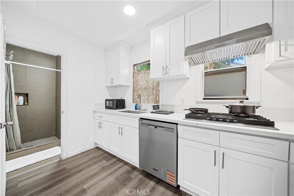 1415 South 2nd Street Alhambra, CA 91801 - Photo 33 of 58 a kitchen with granite countertop white cabinets sink and white appliances