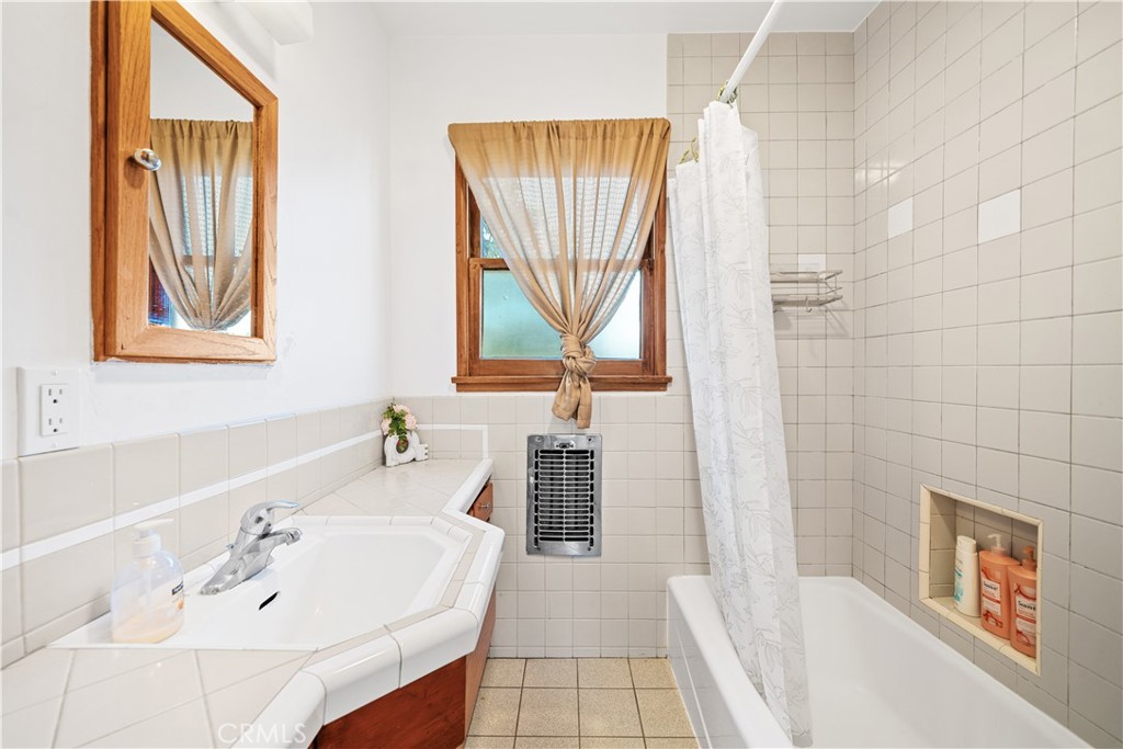 1415 South 2nd Street Alhambra, CA 91801 - Photo 45 of 58 a bathroom with a bathtub a sink a window and a shower