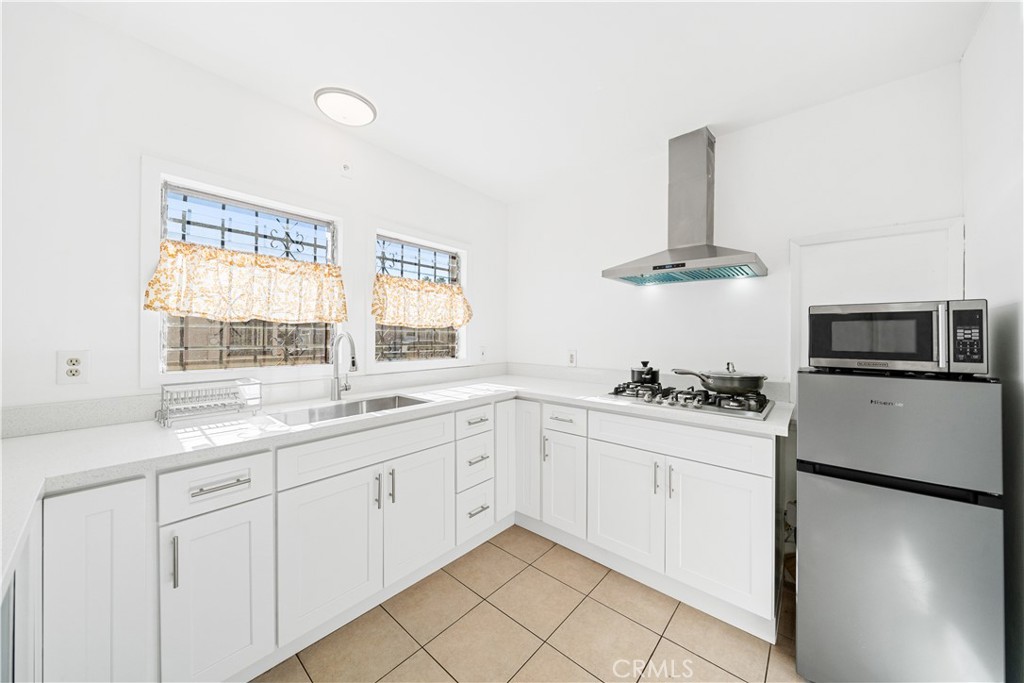 1415 South 2nd Street Alhambra, CA 91801 - Photo 6 of 58 a kitchen with granite countertop white cabinets and white appliances
