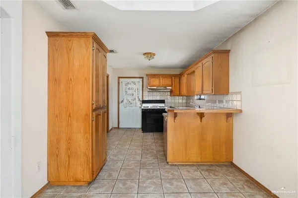 a kitchen with stainless steel appliances granite countertop a refrigerator