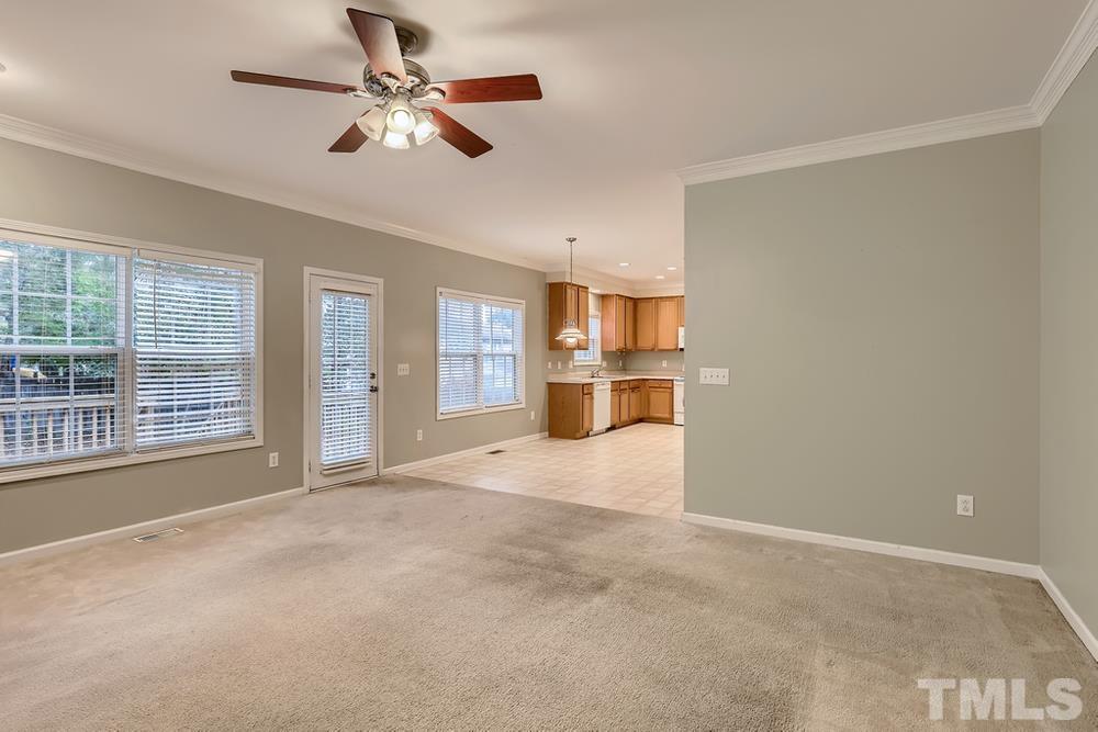 303 Whitney Lane Durham, NC 27713 - Photo 15 of 28 a view of an empty room with a window and a kitchen