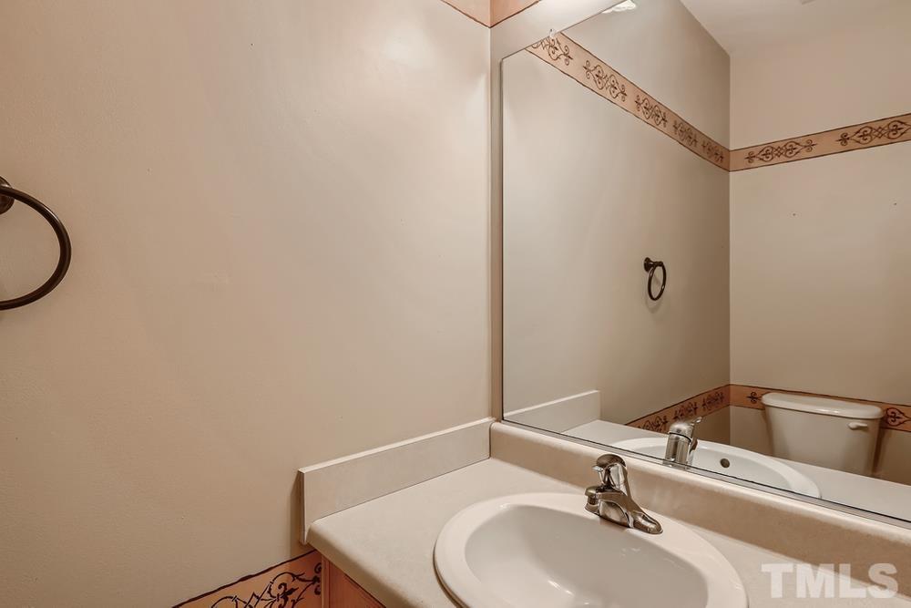 303 Whitney Lane Durham, NC 27713 - Photo 17 of 28 a bathroom with a sink and a mirror