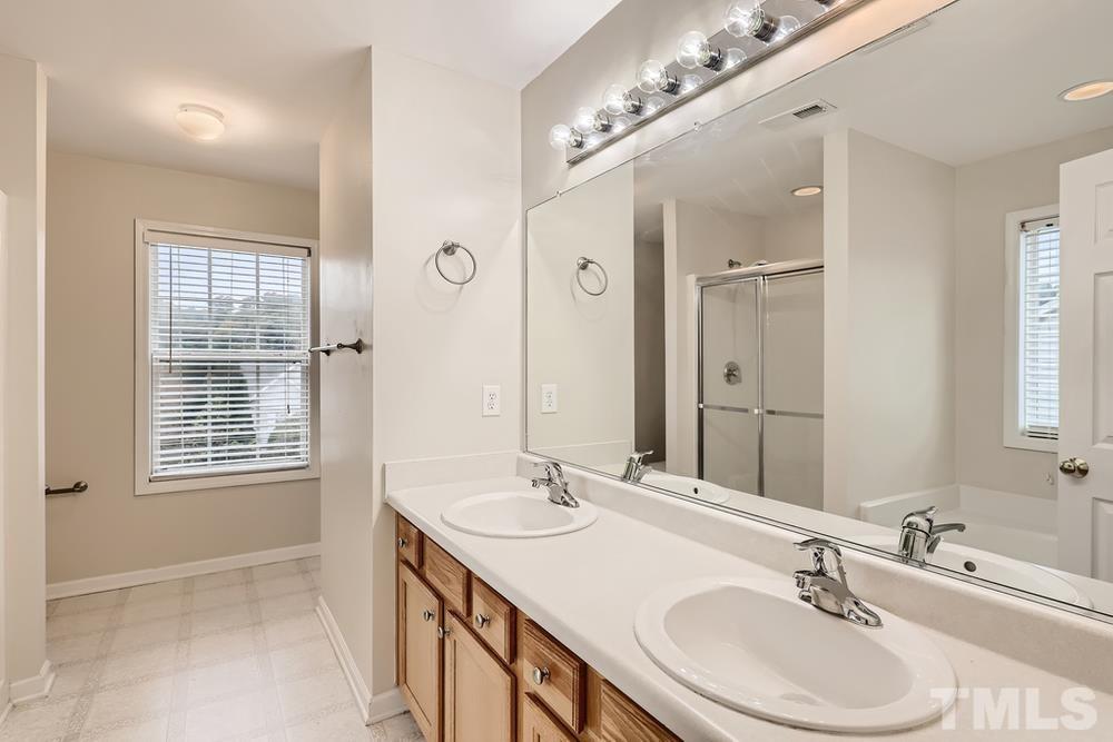 303 Whitney Lane Durham, NC 27713 - Photo 18 of 28 a bathroom with a sink double vanity and a mirror