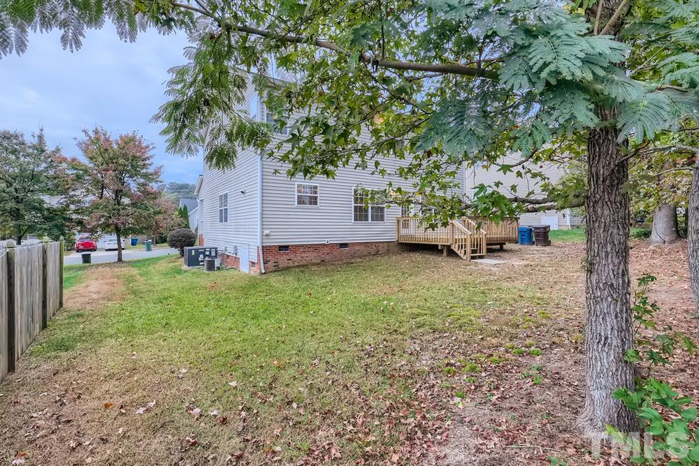 303 Whitney Lane Durham, NC 27713 - Photo 27 of 28 a view of a house with backyard and a tree