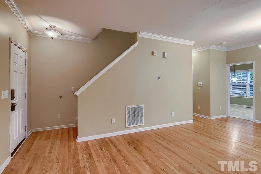 303 Whitney Lane Durham, NC 27713 - Photo 4 of 28 a view of an empty room with wooden floor