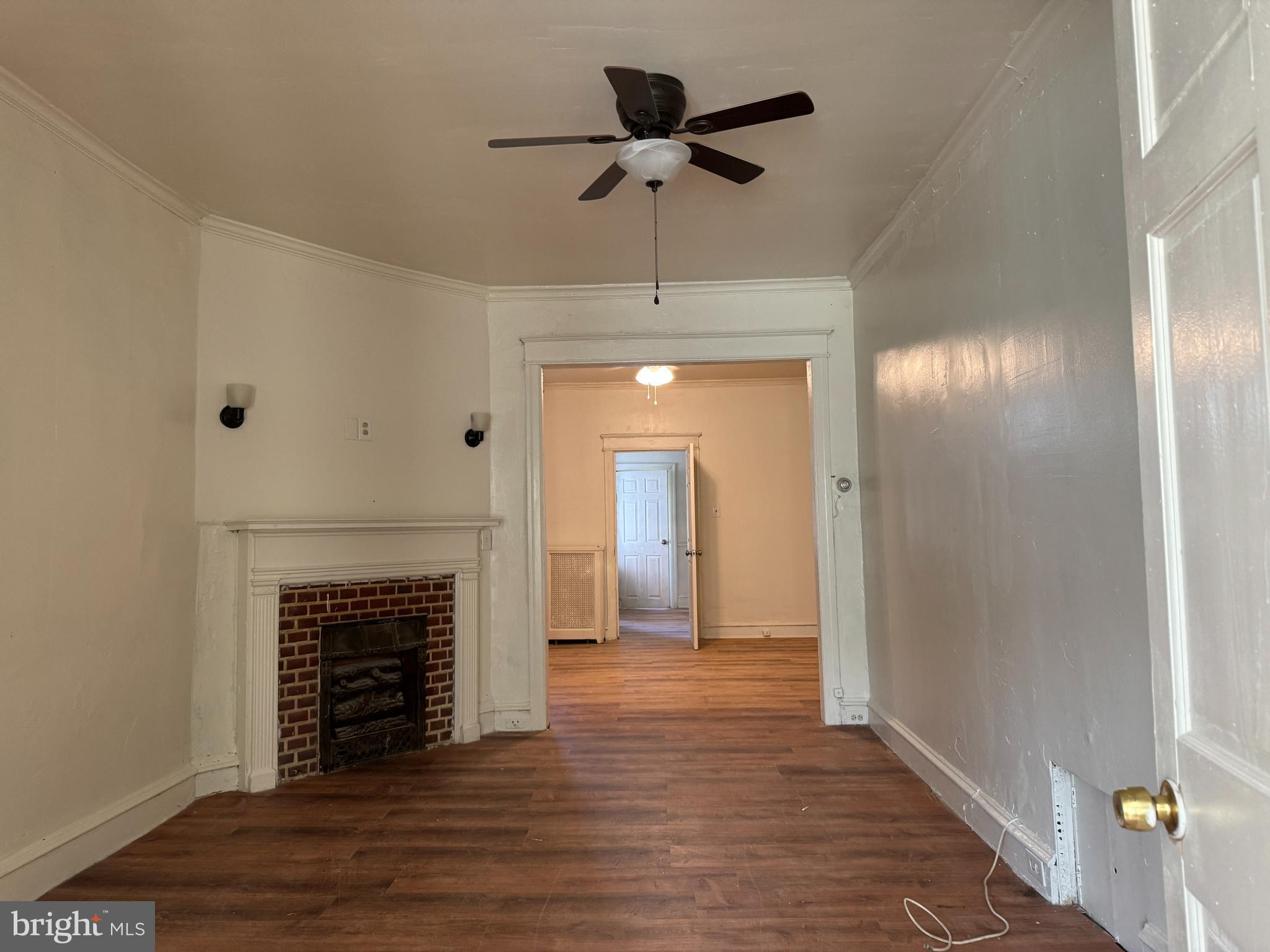 2115 Stenton Avenue Philadelphia, PA 19138 - Photo 6 of 11 a view of an empty room with wooden floor and a fireplace