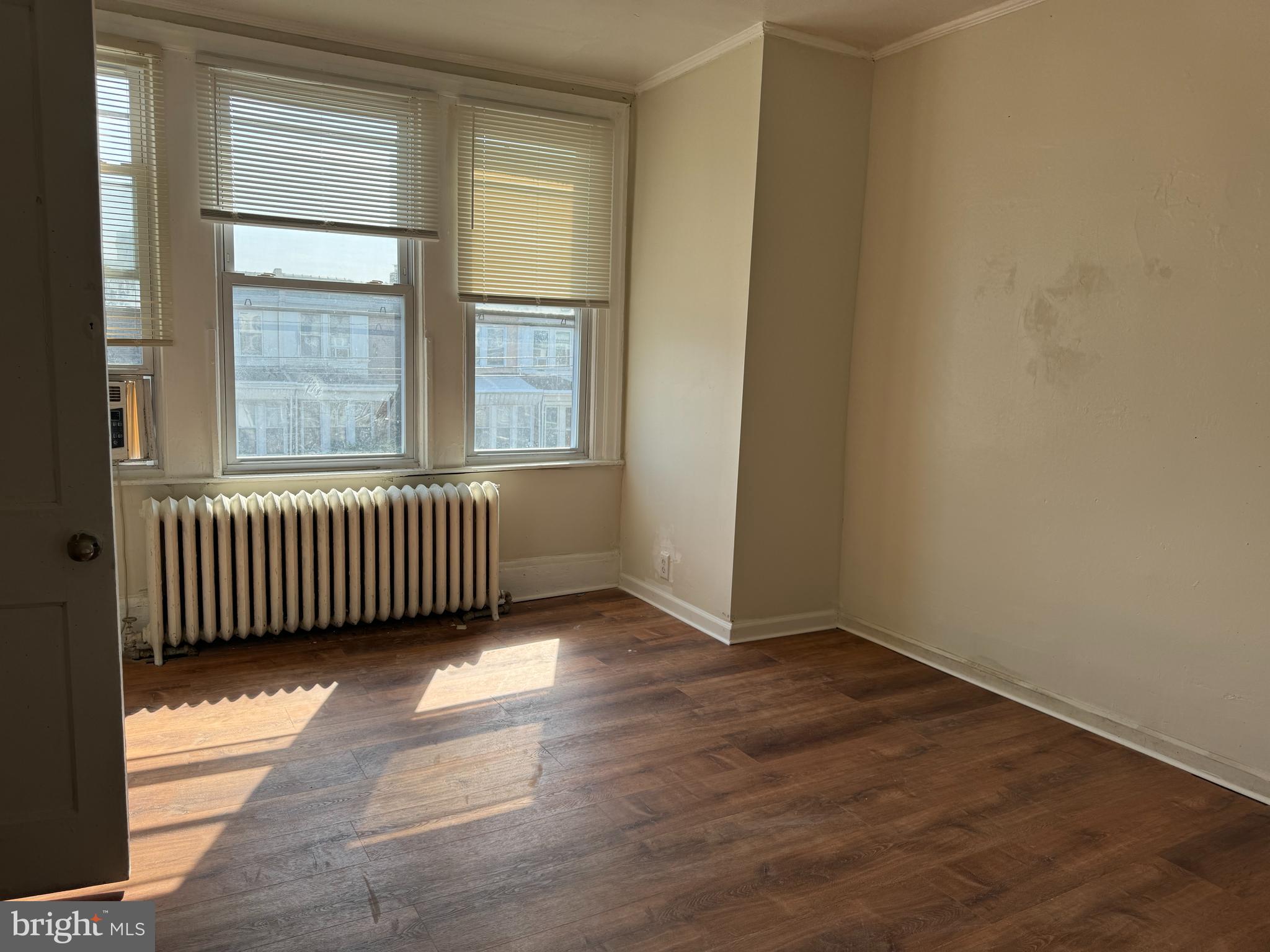 2115 Stenton Avenue Philadelphia, PA 19138 - Photo 9 of 11 an empty room with wooden floor and windows
