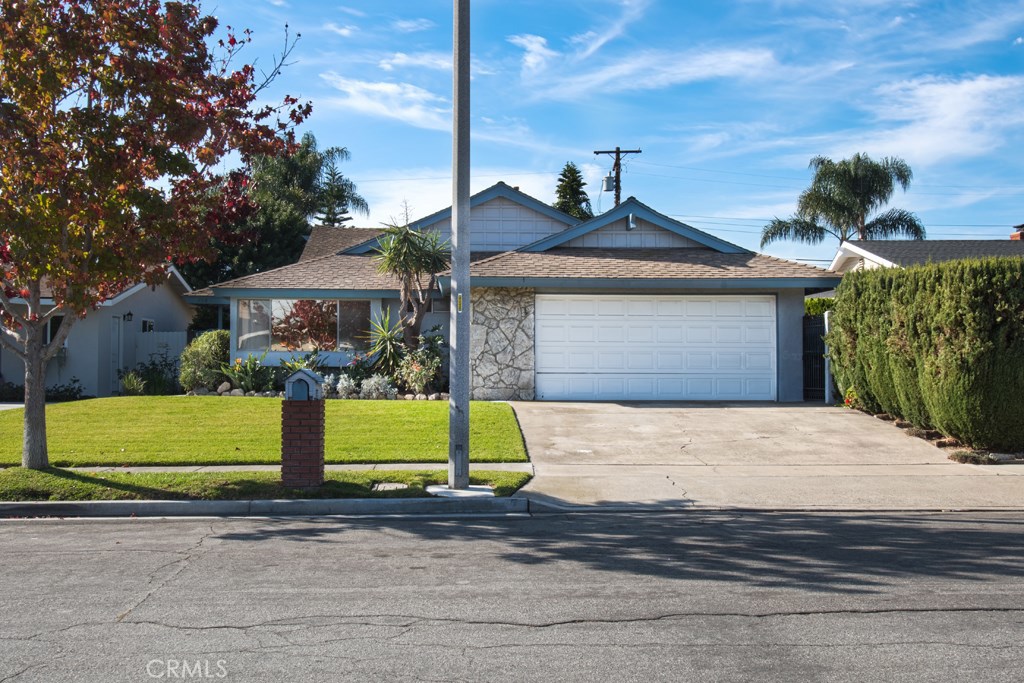 269 Albert Place Costa Mesa, CA 92627 - Photo 1 of 6 a front view of a house with a garden and garage