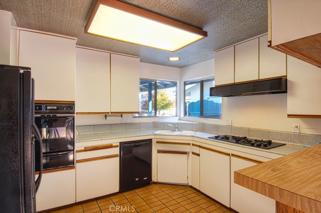 269 Albert Place Costa Mesa, CA 92627 - Photo 5 of 6 a kitchen with stainless steel appliances granite countertop a sink stove and refrigerator