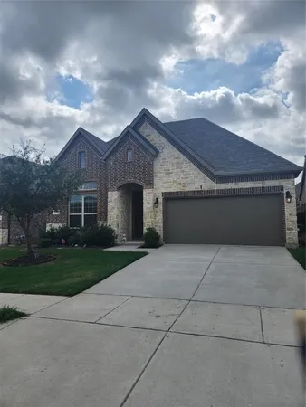 a front view of a house with yard and garden