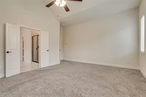 an empty room with chandelier fan