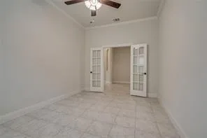 an empty room with chandelier fan
