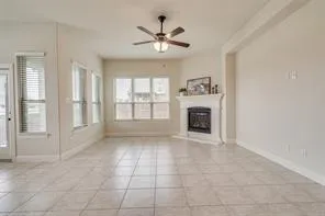 a view of an empty room with a fireplace and a window