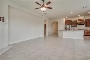 a view of a kitchen with a sink and a refrigerator