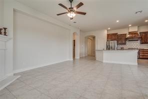 10929 Big Spring Trail McKinney, TX 75071 - Photo 3 of 13 a view of a kitchen with a sink and a refrigerator