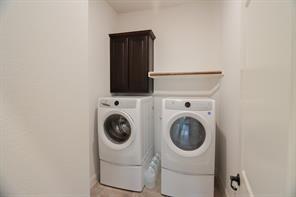 10929 Big Spring Trail McKinney, TX 75071 - Photo 8 of 13 a utility room with dryer and washer