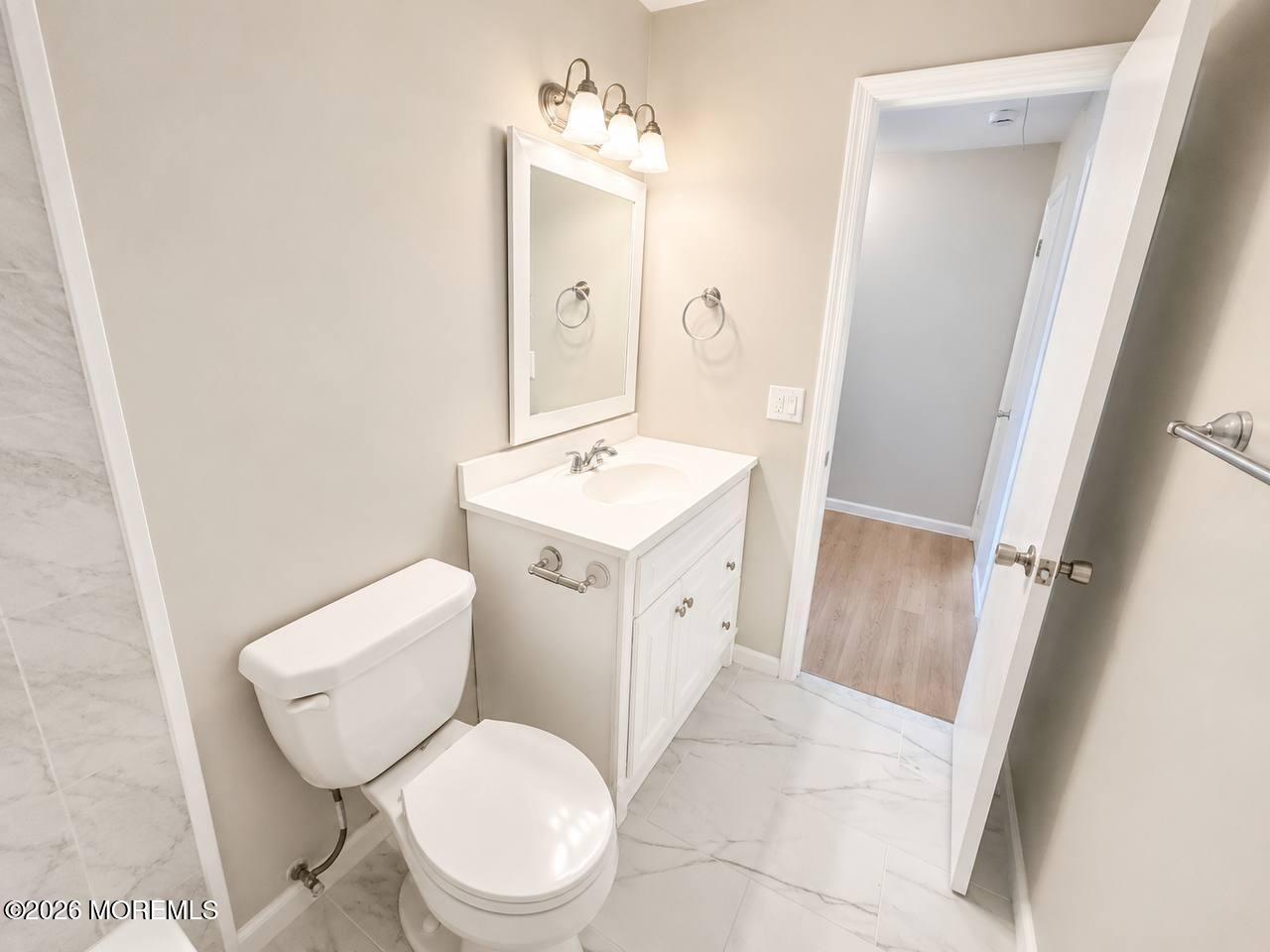 1144 Sawmill Road, Unit 121 Brick, NJ 08724 - Photo 17 of 23 a white toilet sitting next to a bathroom sink