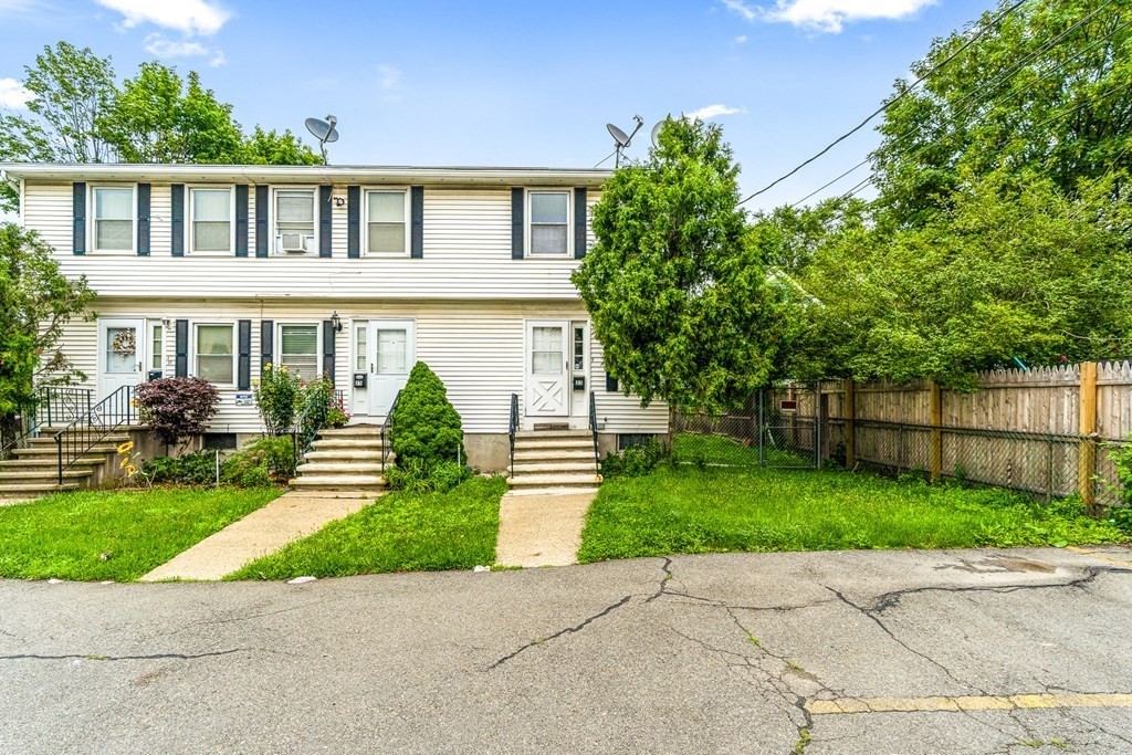 23 Heard Street, Unit 23 Chelsea, MA 02150 - Photo 1 of 27 a front view of a house with a garden and plants