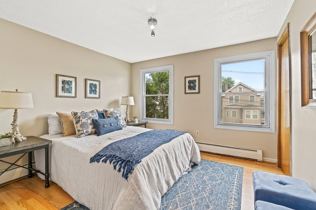 23 Heard Street, Unit 23 Chelsea, MA 02150 - Photo 12 of 27 a bed room with a bed and a couch