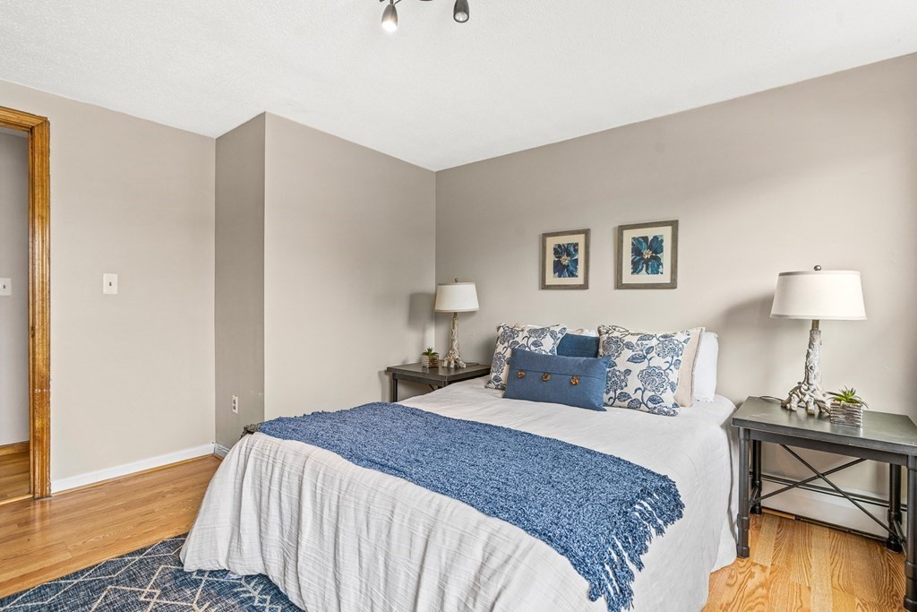 23 Heard Street, Unit 23 Chelsea, MA 02150 - Photo 13 of 27 a bedroom with a bed and a table