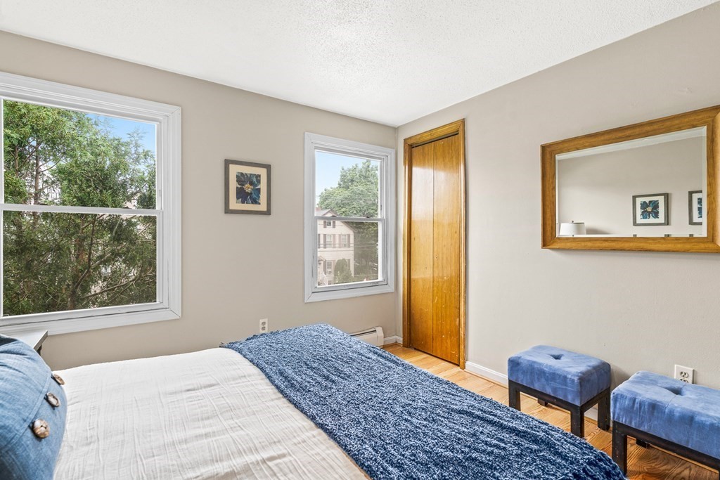 23 Heard Street, Unit 23 Chelsea, MA 02150 - Photo 14 of 27 a bedroom with a bed and wooden floor