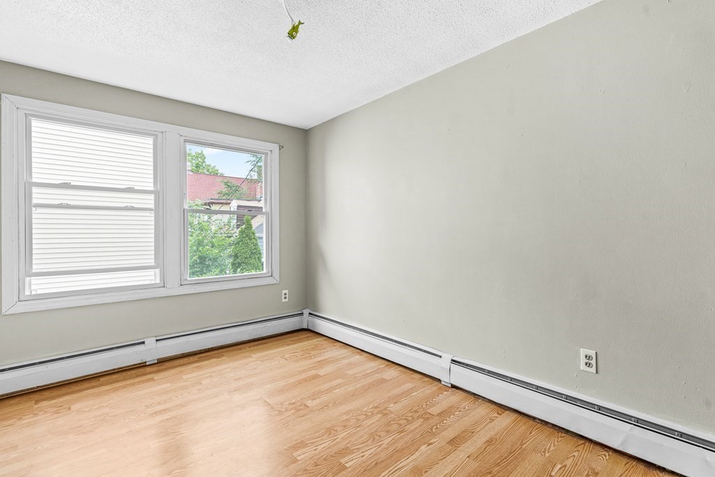 23 Heard Street, Unit 23 Chelsea, MA 02150 - Photo 15 of 27 an empty room with a window