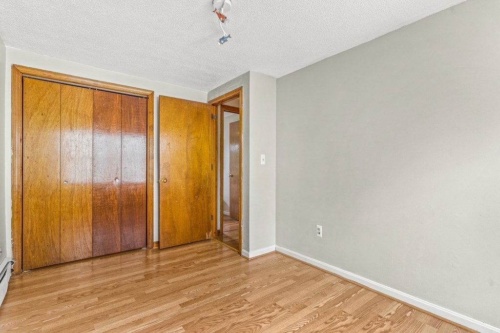 23 Heard Street, Unit 23 Chelsea, MA 02150 - Photo 17 of 27 a view of an empty room with wooden floor and a window