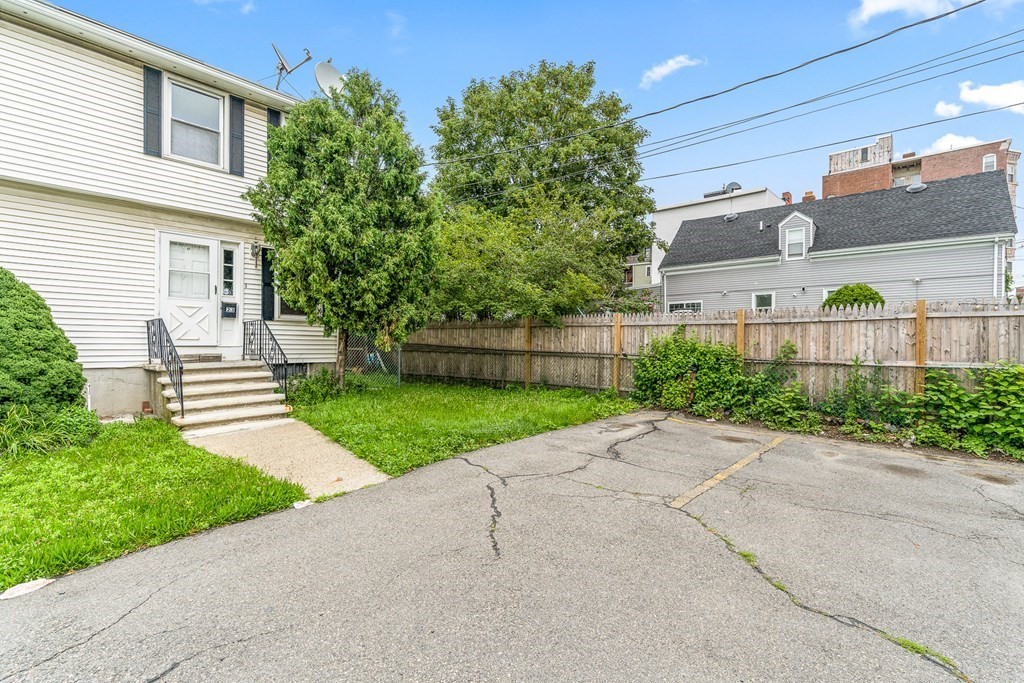 23 Heard Street, Unit 23 Chelsea, MA 02150 - Photo 22 of 27 a view of a house with a yard and plants