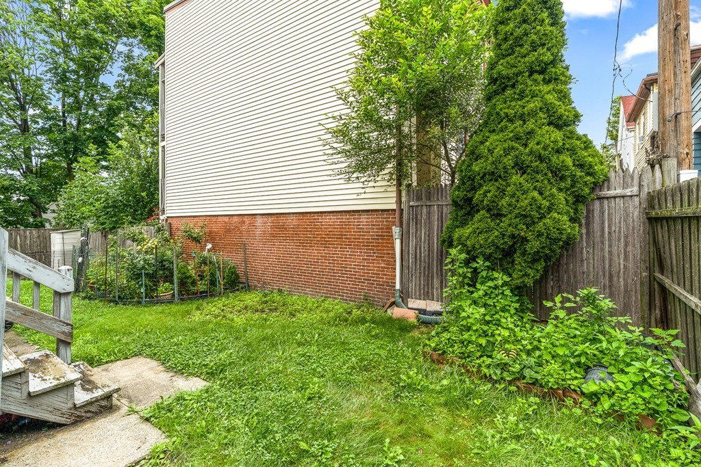 23 Heard Street, Unit 23 Chelsea, MA 02150 - Photo 24 of 27 a view of a backyard with plants and a patio
