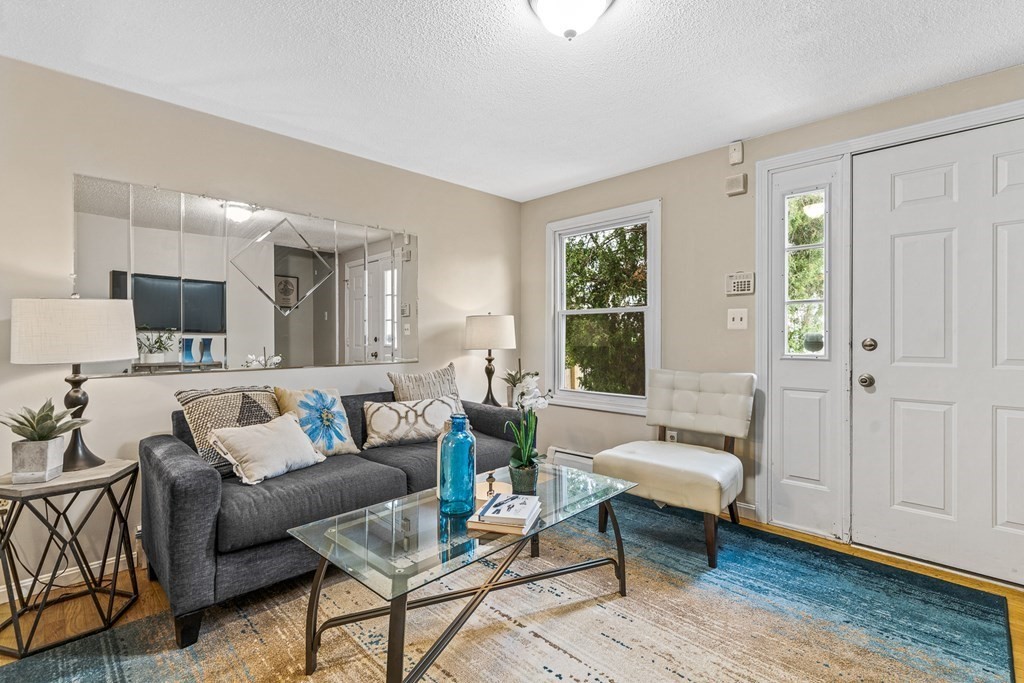 23 Heard Street, Unit 23 Chelsea, MA 02150 - Photo 3 of 27 a living room with furniture and a wooden floor