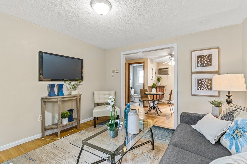 23 Heard Street, Unit 23 Chelsea, MA 02150 - Photo 6 of 27 a living room with furniture and a flat screen tv