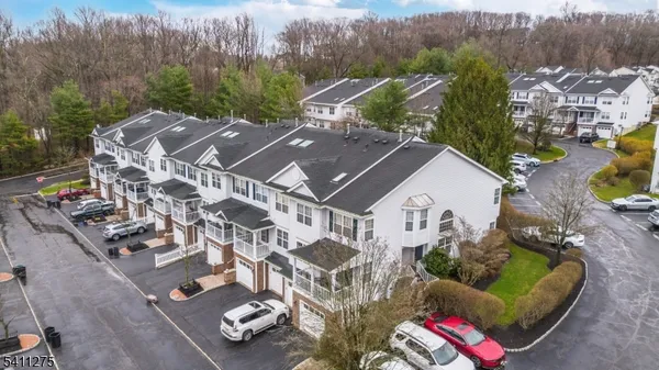 an aerial view of multiple houses with yard