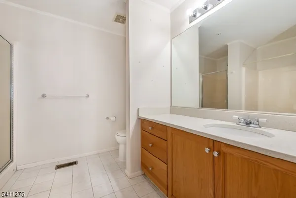 a spacious bathroom with a granite countertop sink and a mirror