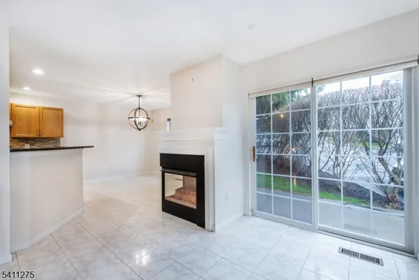 a view of room with flat screen tv and a fireplace