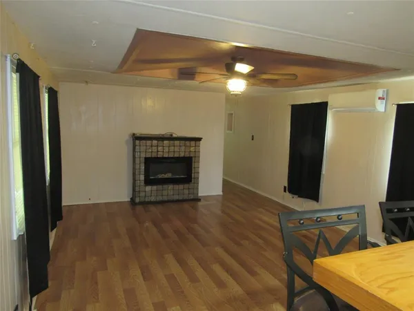 a view of a livingroom with a fireplace and wooden floor