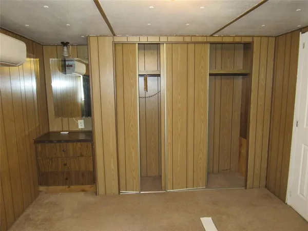 a view of a room with furniture and wooden floor