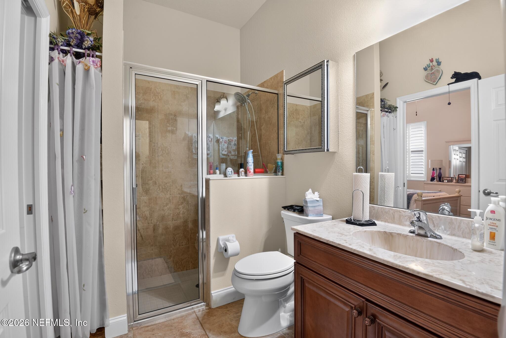 110 Vía Roma Ormond Beach, FL 32174 - Photo 29 of 43 a bathroom with a granite countertop sink toilet and shower